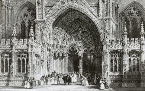 Black and white photograph. This photograph is of an engraving, so it appears to be a print at first glance. Dozens of people, the men in full suits and hats and the women in long, hoop skirts, are tiny in scale as they mill under the massive archivolt of Lincoln Cathedral.